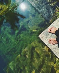 Low section of man with reflection in water