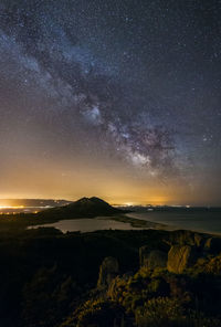 Scenic view of rocks against sky at night