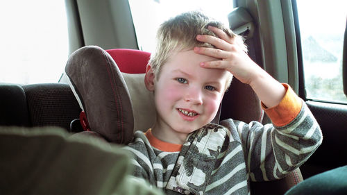 Portrait of boy sitting on sofa