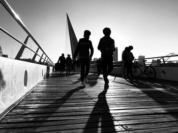 People walking on footbridge