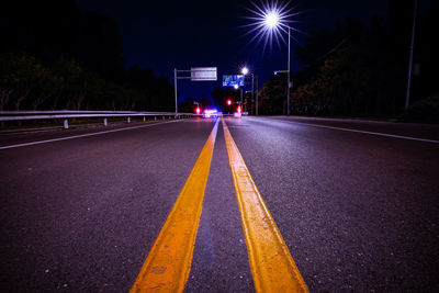 Illuminated light trails on road at night