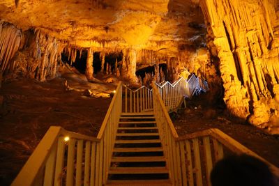 Low angle view of steps in illuminated cave