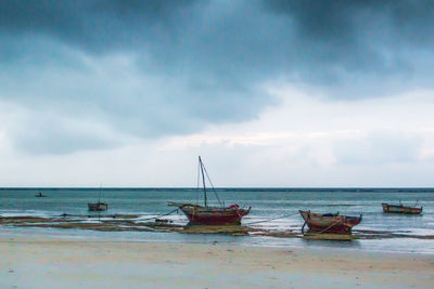 Boats moored on sea against sky