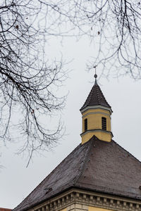 Low angle view of building and trees against sky