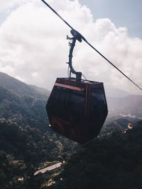 Low angle view of overhead cable car against sky