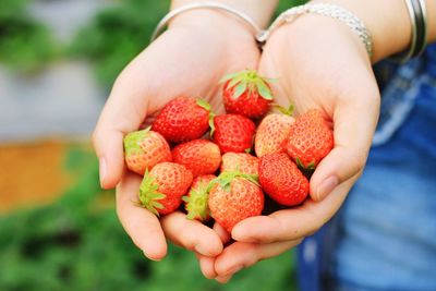 Close-up of woman holding fruits