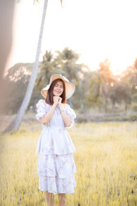 Portrait of woman standing on field