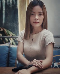 Portrait of beautiful woman sitting at home