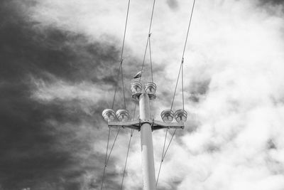 Low angle view of weather vane against sky