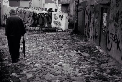 Full length of woman walking on tiled floor