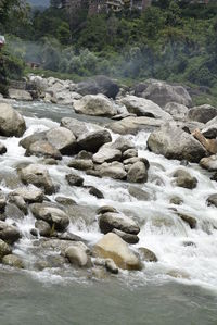 Scenic view of river flowing through rocks