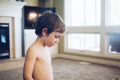 Close-up of young boy in living room