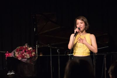 Full length of senior woman standing on stage