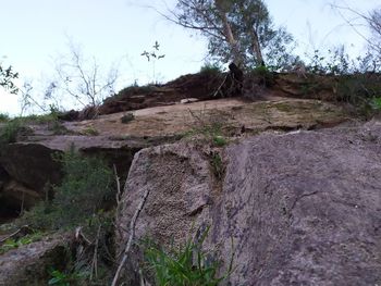 Low angle view of rocks on land against sky