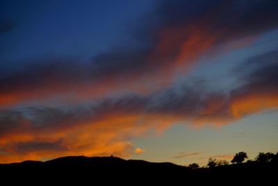 Low angle view of dramatic sky during sunset
