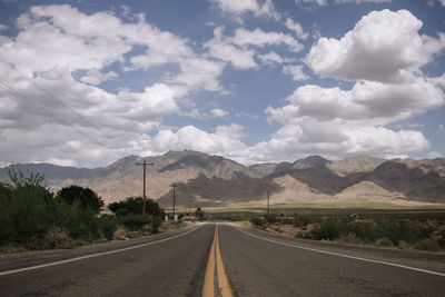 Empty road along countryside landscape