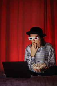 Young woman using laptop while sitting at home