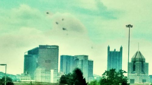 Low angle view of buildings against cloudy sky