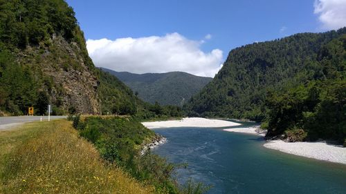 Scenic view of sea and mountains against sky