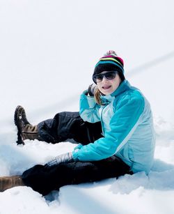 Portrait of smiling young woman in snow