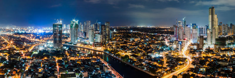 High angle view of city lit up at night