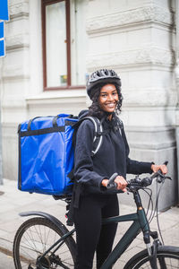 Woman riding bicycle on city street