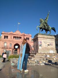 Statue against blue sky in city