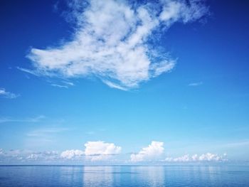 Scenic view of sea against blue sky