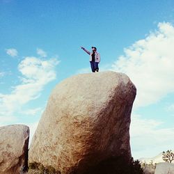 Low angle view of silhouette man standing against sky