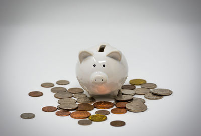 Close-up of coins on table against white background