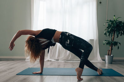 Yogic woman practicing in yoga studio