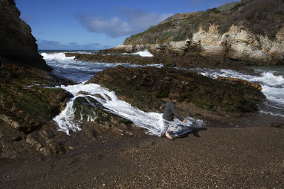 Boy running at sea shore