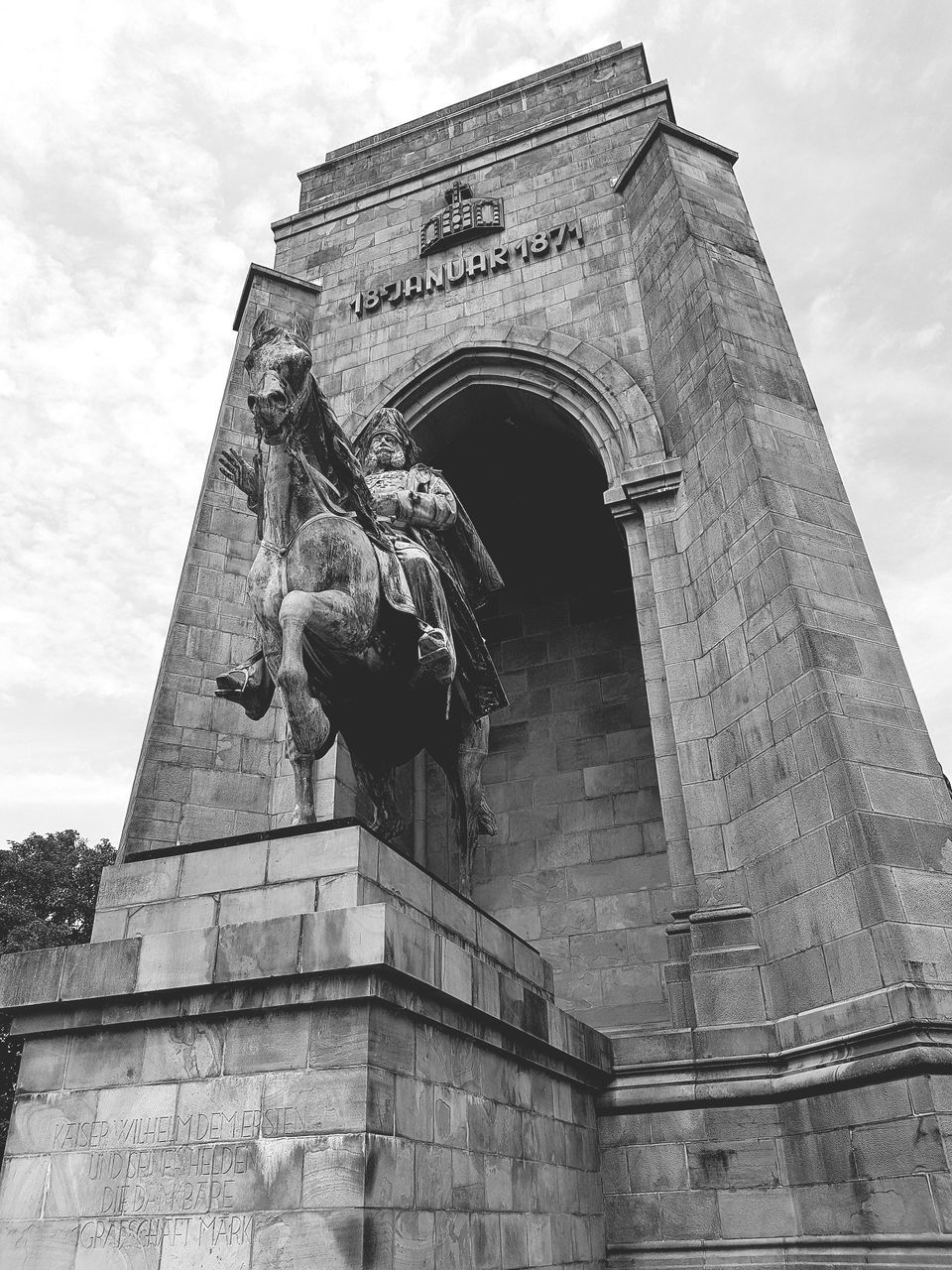 architecture, low angle view, built structure, statue, art and craft, sculpture, sky, human representation, representation, building exterior, history, the past, cloud - sky, arch, nature, day, travel destinations, male likeness, no people, creativity, outdoors, architectural column