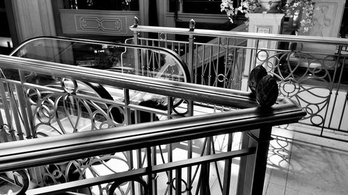 Man standing by railing in city