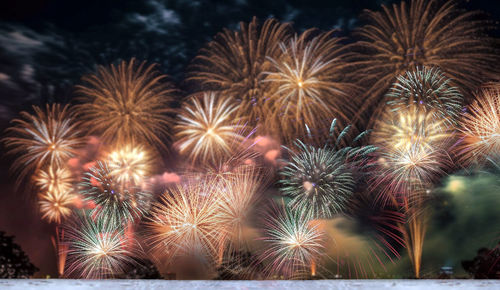 Low angle view of firework display at night