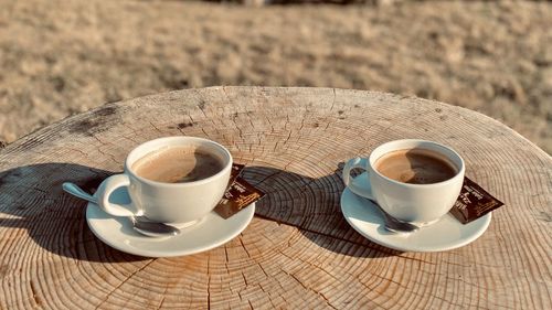 Coffee cup and tea on table