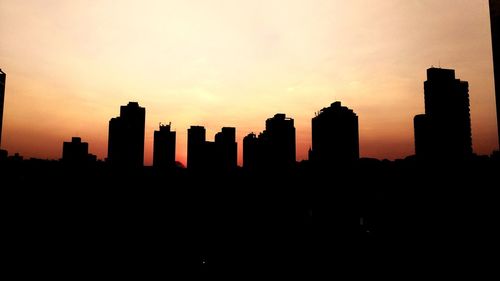 Silhouette of city at sunset