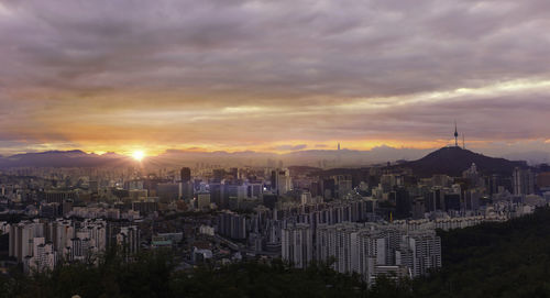 Cityscape against sky during sunset