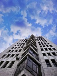 Low angle view of modern building against blue sky