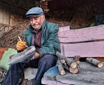 Portrait of a smiling young man sitting outdoors