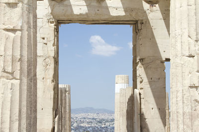 Residential district seen through doorway in historical building against sky