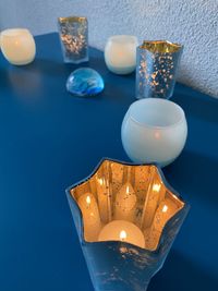 High angle view of illuminated candles on table