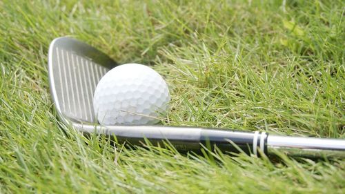 Close-up of golf ball on field