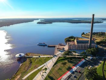 High angle view of city by sea against sky