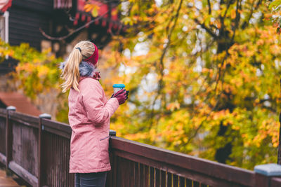 Woman having coffee while looking at view