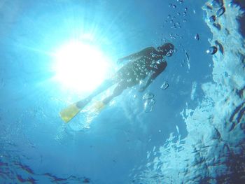 Low angle view of man swimming undersea