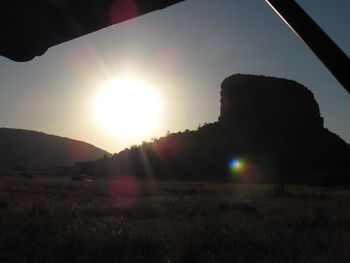 Scenic view of field against sky at sunset