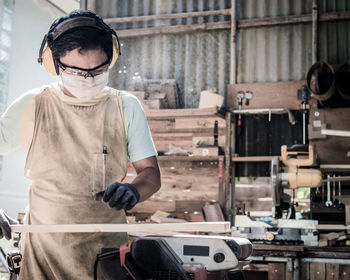 Carpenter working on wood in workshop