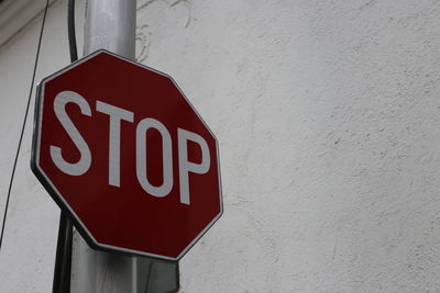 Close-up of arrow sign on wall