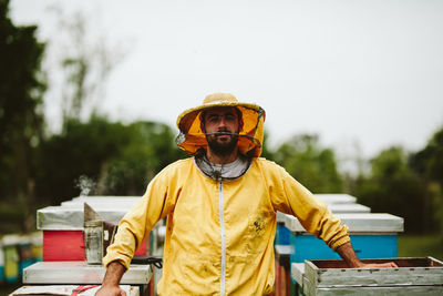 Beekeeper working over beehive at farm